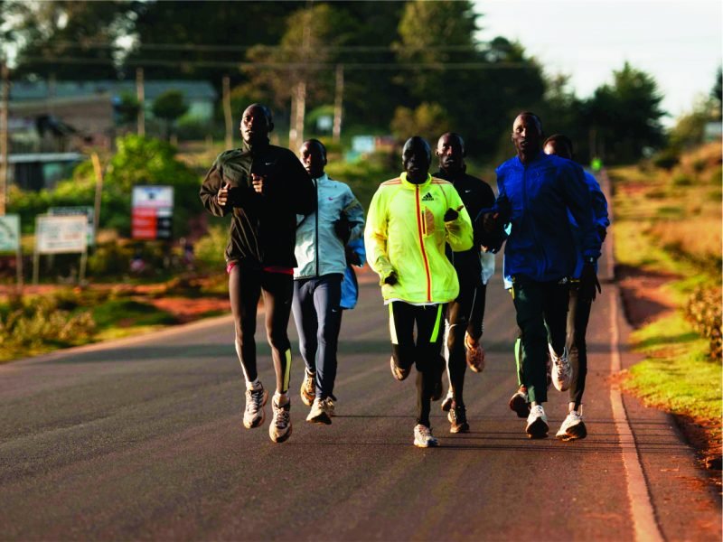 A group running on the tarmac road near Iten